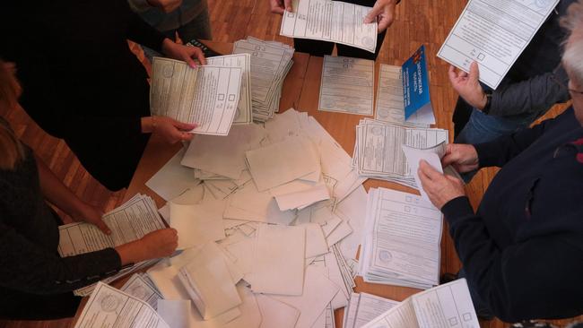 Election commission members count votes of refugees from Russian-held regions of Ukraine for a referendum at a polling station in Simferopol, Crimea, on September 27.