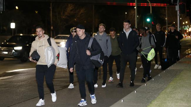 A-League players prepare to board a bus at AAMI Park on Tuesday before their plans for leaving Melbourne fell through