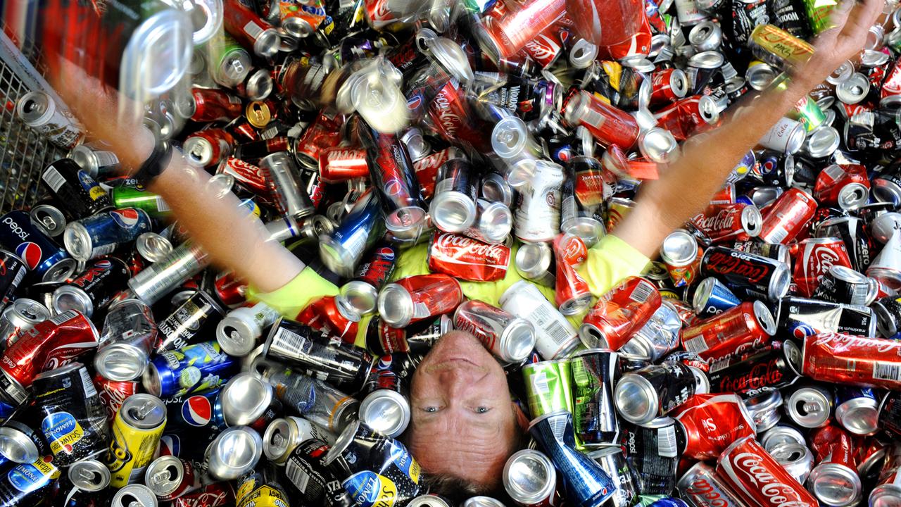 Daws Road Recycling employee Matt Fisher with soft drink cans, which can be recycled.