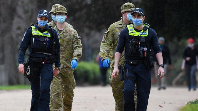 Police officers and soldiers on patrol at The Tan. Picture: William West/AFP