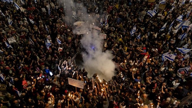 Protesters light a fire and hold flame torches during a demonstration calling for a hostages deal and against the Israeli government on April 6. Picture: Getty Images