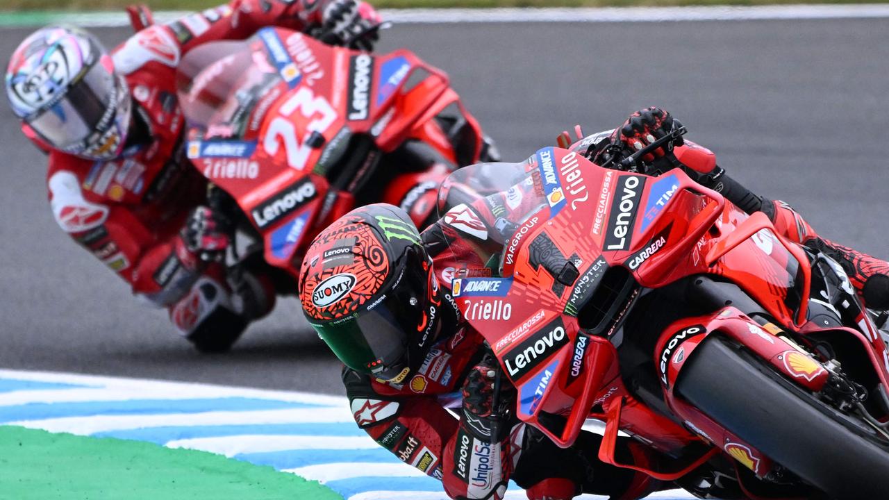 Ducati Lenovo Team rider Francesco Bagnaia of Italy (R) leads his teammate Enea Bastianini of Italy (L) during Tissot Sprint of the MotoGP Japanese Grand Prix at the Mobility Resort Motegi in Motegi, Tochigi prefecture on October 5, 2024. (Photo by Toshifumi KITAMURA / AFP)