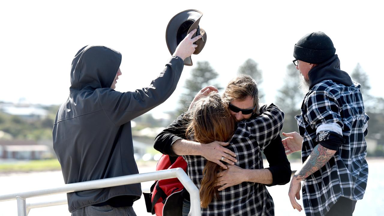 Derek Robinson is reunited with his family as he disembarks on to Granite Island. Picture: NCA NewsWire / Picture: Naomi Jellicoe