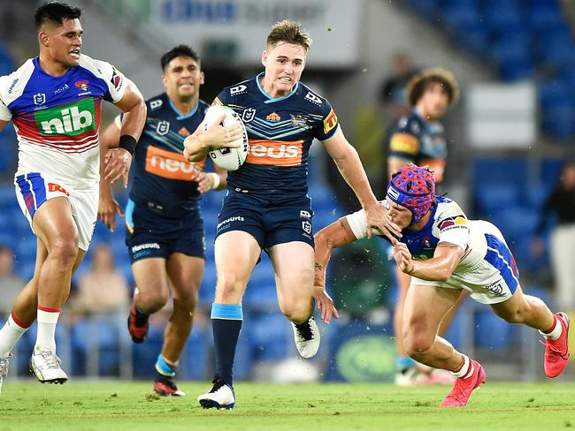 AJ Brimson evades an attempted tackle by his mate, and Origin rival, Kalyn Ponga. Picture: Matt Roberts/Getty Images