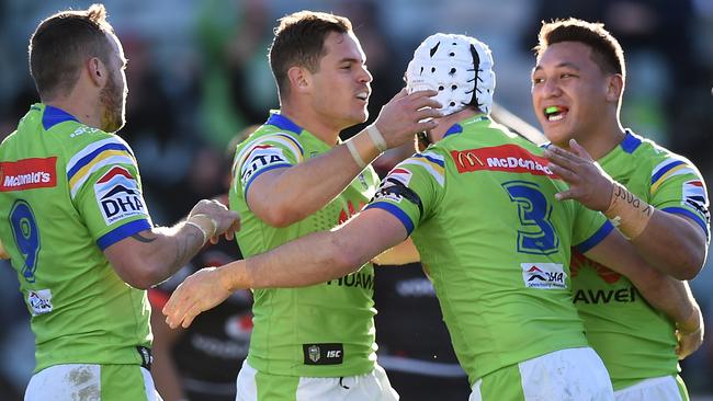 Jarrod Croker of the Raiders, (centre), celebrates with teammates after scoring a try.