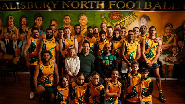 Gavin Wanganeen and daughter Lulu with Eugene Warrior and Salisbury North players. The Hawks sealed their spot in division two for season 2023. Picture: Matt Turner.