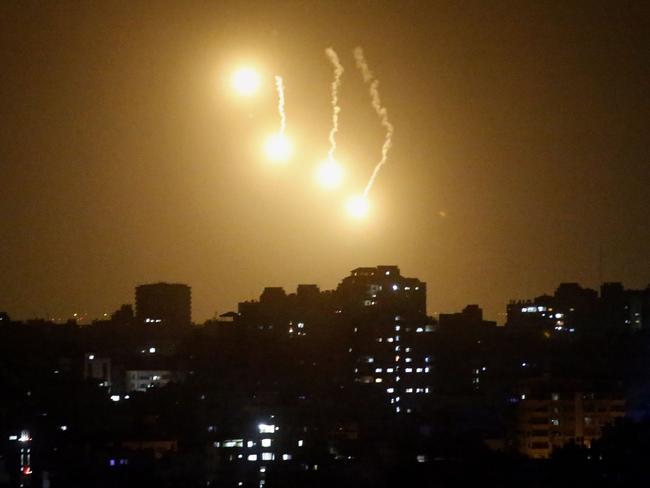 Flares fired by the Israeli army illuminate the sky over the northern part of Gaza City, on July 19. AFP PHOTO / THOMAS COEX
