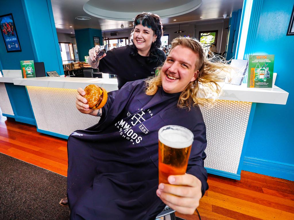 Hunter Rackemann gets his mullet trimmed by Jimmy Rods barber Grace Pymble. Picture: Nigel Hallett