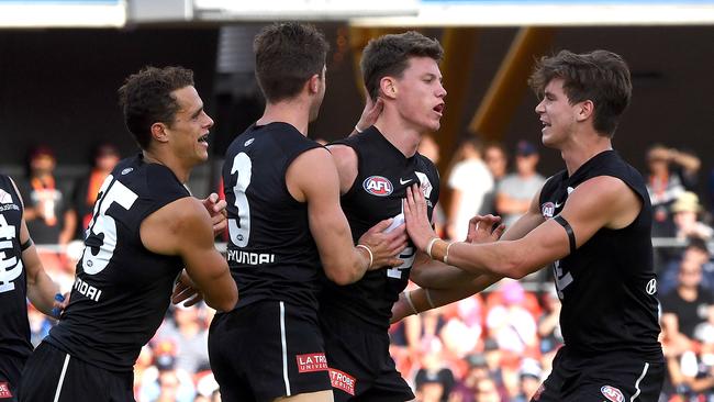 Sam Walsh is congratulated after kicking a goal during the Blues’ loss to Gold Coast. Picture: AAP Image/Dave Hunt.