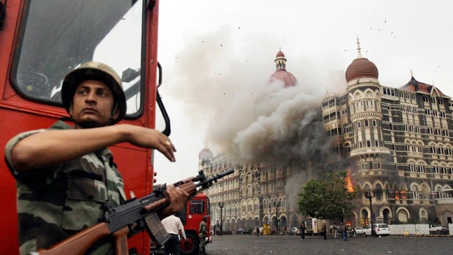 The Taj Mahal hotel burns during a gunfight between Indian troops and insurgents in Delhi, 2008. Picture: David Guttenfelder/AP