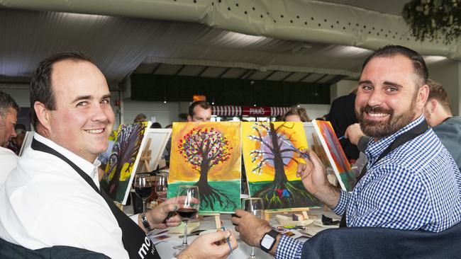 Ross Crampton (left) and Brett Gray participate in the World's Largest Paint and Sip Luncheon for Momentum Mental Health at Clifford Park racecourse, Friday, June 21, 2024. Picture: Kevin Farmer