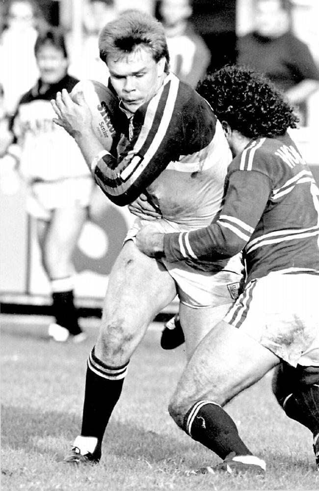 Troy McCarthy tackled by Cliff Lyons. Gold Coast v Manly.