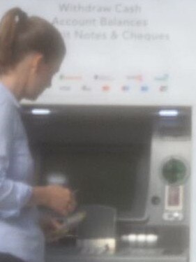 John Woodman's assistant, Joeleen Rohm, seen withdrawing cash from an ATM.