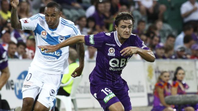 Perth Glory defender Josh Risdon pushes past Archie Thompson.