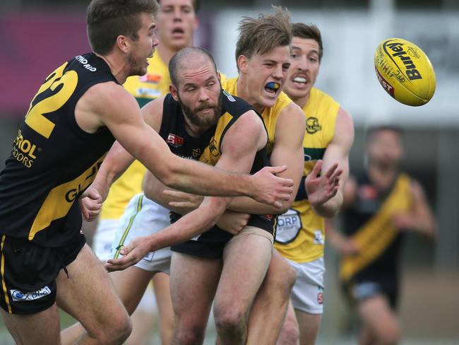 SANFL: Glenelg v Eagles at Glenelg Oval 23 June 2018. Glenelg's Aaron Joseph gets a handball out under pressure. (AAP Image/Dean Martin)