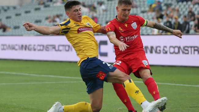 Lewis Miller of the Central Coast Mariners contests the ball with Michael Jakobsen of Adelaide United. Picture: Getty Images