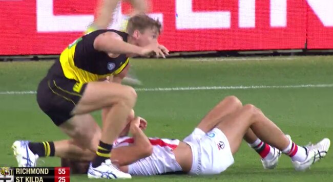 Tom Lynch drops his knee into his opponent.