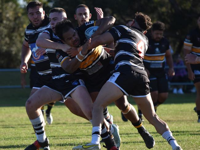 Drey Mercy is tackled by Andrew Willis (number four) and Harrison Marsh. Picture: Sean Teuma/NewsLocal