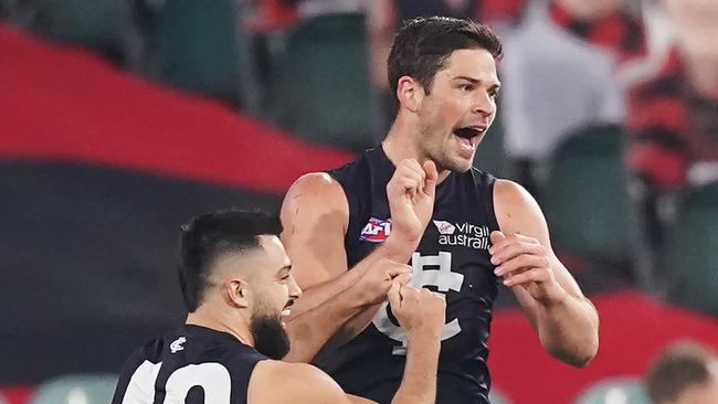 Levi Casboult and Michael Gibbons enjoy a goal from the Carlton forward.