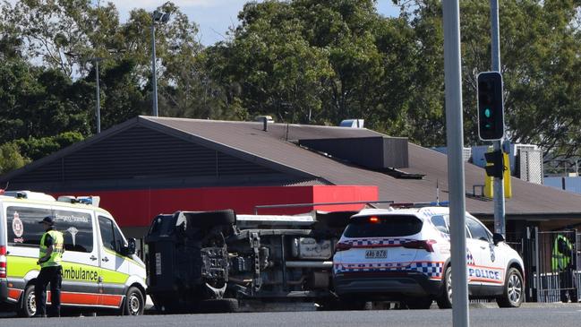 A police car has rolled during a crash outside a Gladstone McDonald’s.