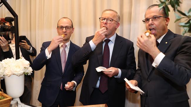 Mr Albanese, centre, tucks into a cannoli pictured at the Marconi Club. Picture: Sam Ruttyn