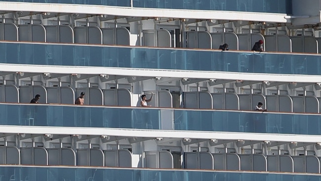 Crew could be seen on board the Ruby Princess as it docked at Port Kembla. Picture: John Grainger.