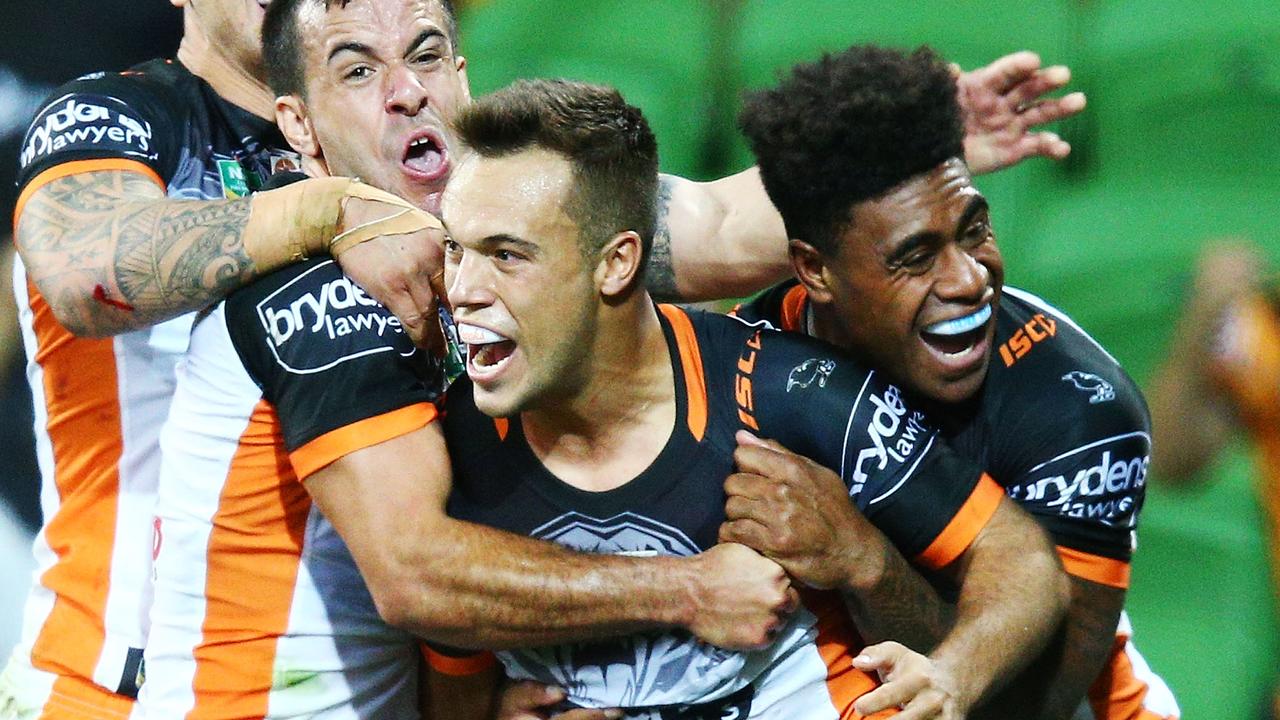 Luke Brooks of the Tigers celebrates a try.