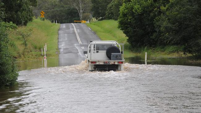 A 4WD heads through flood waters on the Mary Valley Highway.