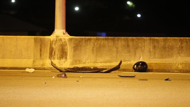 A helmet and front bumper on the road after the collision Picture: Steve Tyson