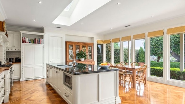 The gourmet kitchen and meals area at 25 Watts Pde has a long skylight and generous granite stone benchtops.