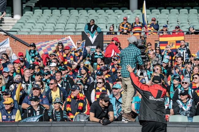 Crows and Port Adelaide fans cheering and sitting together on the southern side of Adelaide Oval as extras in the film 