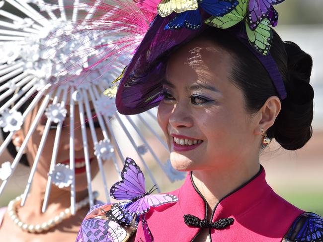 Women sporting fancy hats prepare for the annual Fashion on the Field competition at Flemington Racecourse on Melbourne Cup day in Melbourne on November 3, 2015. Picture: AFP PHOTO/Paul CROCK