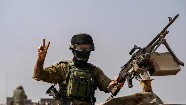 an Israeli army soldier manning a turret atop an armoured vehicle near the Gaza border in southern Israel. Picture: AFP