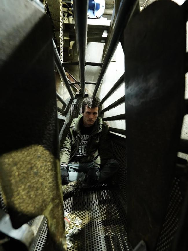 Activist Chris Delforce sits inside a gondola used to lower pigs into gas. Picture: Supplied