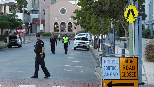 Police guard an empty Hinze Street. Picture: Glenn Hampson.