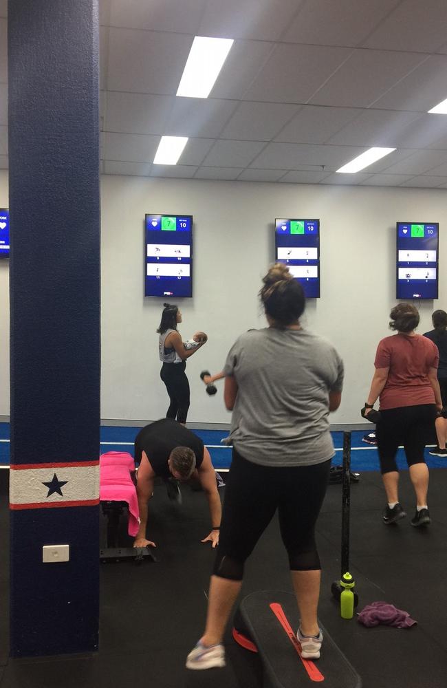 Mum Manawa Ruki (grey shirt) continues an intense workout as Morgan cradles her five-week-old.