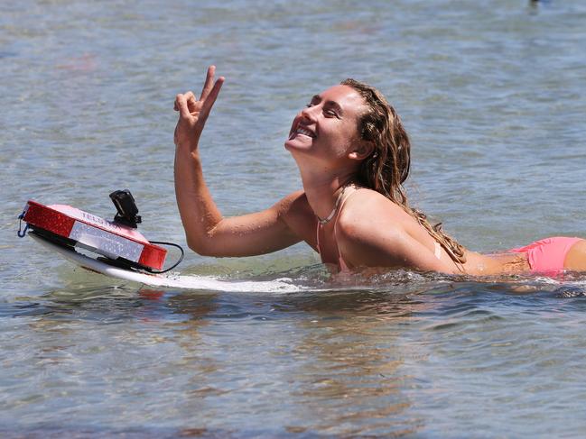 Telstra 5G drone tests at Labrador show how the next generation of mobile technology will be a critical element in powering new innovations that will help save lives on Australian beaches.Champion surfer Nikki Van Dijk takes part in the 5G drone demonstrations. Picture Glenn Hampson