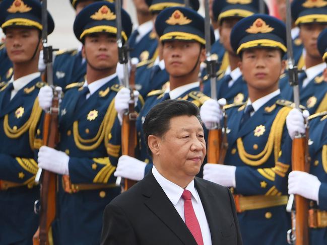 (FILES) This file photo taken on July 22, 2019 Chinese President Xi Jinping (C) walking past a military honour guard during a diplomatic visit by Saudi Arabia outside the Great Hall of the People in Beijing. - Xi warned on November 11, 2021 against a return to Cold War-era tensions in the Asia-Pacific, urging greater cooperation on pandemic recovery and climate change. (Photo by GREG BAKER / AFP)