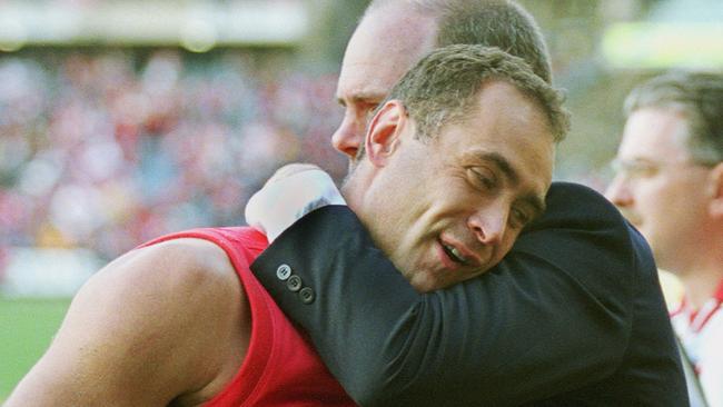 Schwass gets a hug from coach Rodney Eade in 2001.