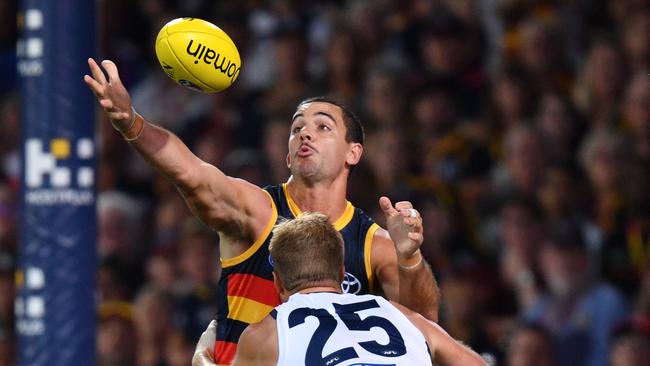 Taylor Walker of the Crows is tackled by Lachie Henderson last week. Picture: AAP Image/David Mariuz