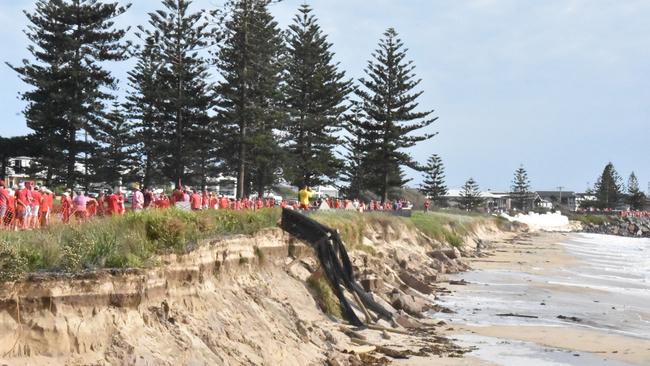 Thousands gathered at Stockton Beach to form a red line across the beach erosion that continues to see the beach disappearing. Supplied.