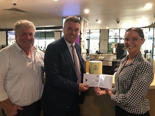 AHA NSW Illawarra sub-branch delegate Mick Dennis (left), AHA NSW director of liquor and policing John Green and The Oaks Hotel general manager Belinda Williams with the $1000 donation to the RFS.