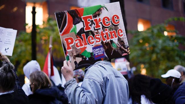 Activists hold signs in support of Palestinians and a ceasefire, outside US Senator Chuck Schumer's offices in New York. Picture: AFP.