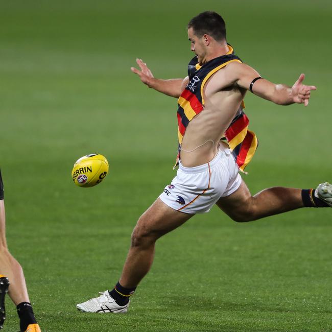 Darcy Fogarty gets a kick away with his shirt ripped. Picture: Getty Images