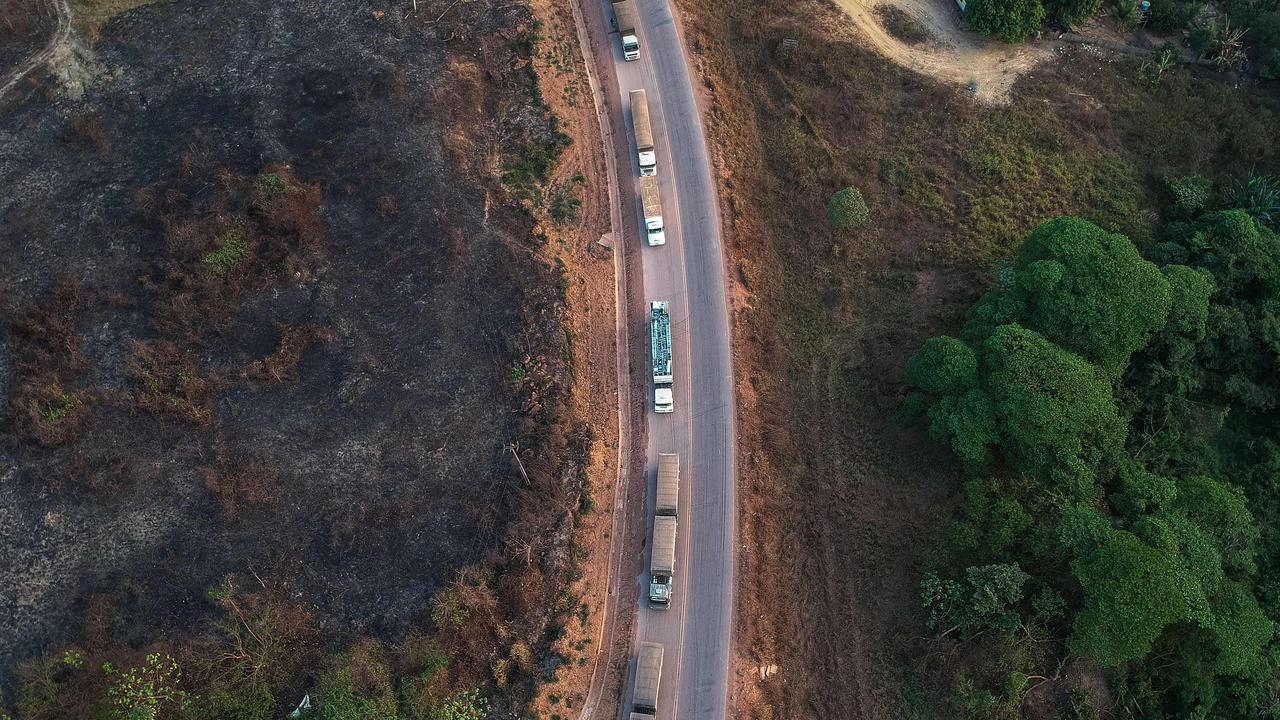 Trucks queue along the BR163 highway, in Moraes Almeida district, Itaituba, Para state, Brazil, in the Amazon rainforest. Increased traffic to the region brings other problems. (Photo by Nelson Almeida / AFP)