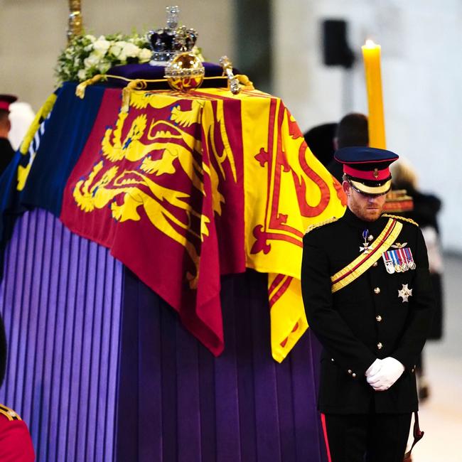 Prince Harry, Duke of Sussex holds a vigil beside the coffin of their grandmother as it lies in state on the catafalque inside Westminster Hall.