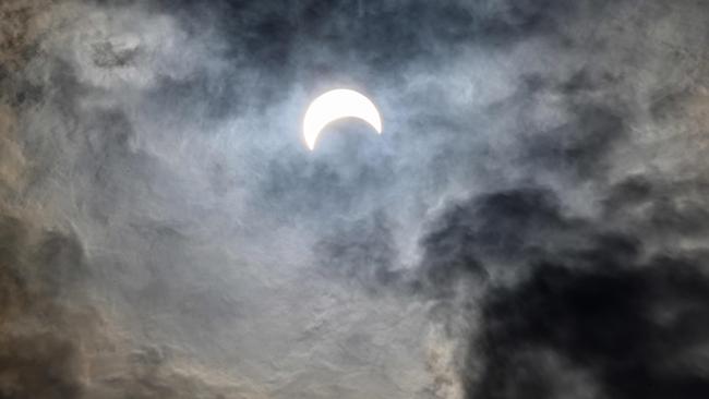 The moon covers the sun in a rare ‘ring of fire’ solar eclipse as seen from Bangkok on Thursday. Picture: AFP