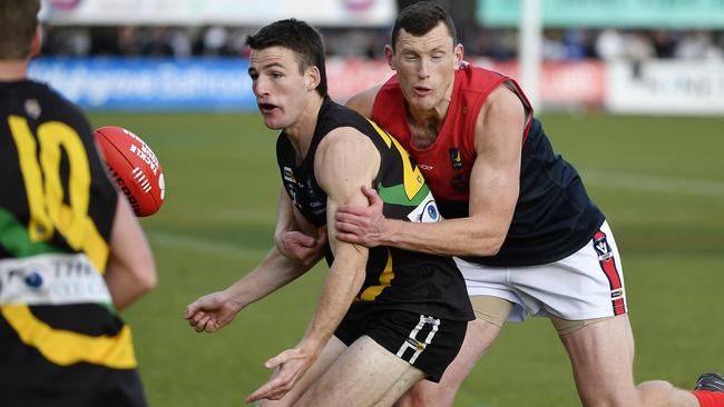 Mt Eliza ruckman Chris Carey tackles Dromana player Riley Davis. Picture: Andrew Batsch