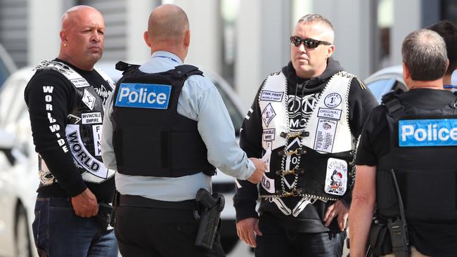 Finks members, including president Koshan Rashidi (left) speak with police outside their Cranbourne clubhouse. Picture: David Crosling