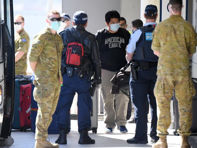 Crew from the Ruby Princess cruise ship are seen arriving at Sydney International Airport in Sydney, Thursday, April 23, 2020. The Ruby Princess cruise ship has been told to leave Australia by Thursday, as an inquiry begins. (AAP Image/Dan Himbrechts) NO ARCHIVING